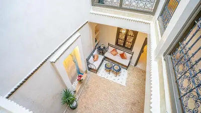 an overhead view of a living room with a couch and tables at Riad Le Soleil Rouge in Marrakech