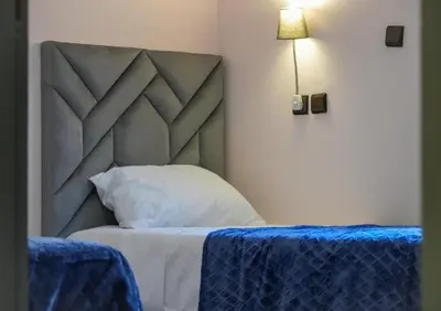 a bedroom with a bed with a blue table cloth at Appartement Moderne a Marrakech - 2 Chambres, Salon et Cuisine Equipee in Marrakech