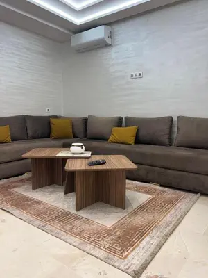 a living room with a couch and a coffee table at Des appartements conçus pour votre confort in Marrakech