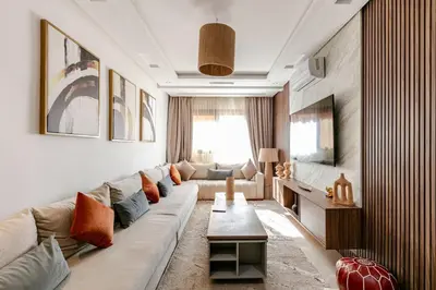 a living room with a couch and a table at Modern & Refined Apartment Majorelle Downtown in Marrakech