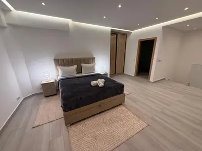 a bedroom with a bed with a stuffed animal on it at Residence miraj in Marrakech