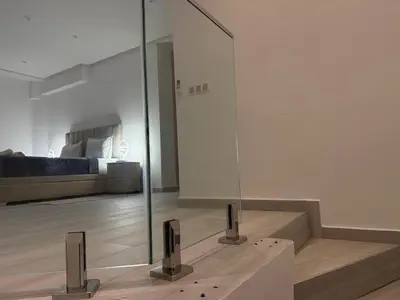 a glass wall in a living room with a bed at Residence miraj in Marrakech