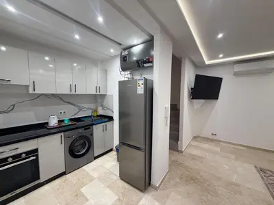 a kitchen with a refrigerator and a dishwasher at Residence miraj in Marrakech