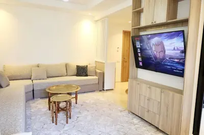 a living room with a couch and a flat screen tv at Marrakech Noria Golf, cosy appartement 2 chambres in Marrakech