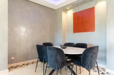 a dining room with a table and chairs at Luxury Villa Private Pool & Golf View 7 min to center in Marrakech