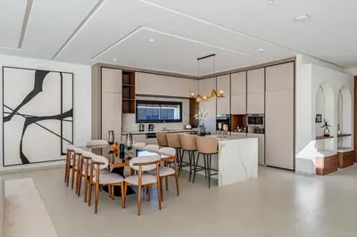 a kitchen and dining room with a table and chairs at Villa Lilas-Luxe Pool, Steam Room & Gym in Segraga
