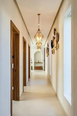 a hallway of a house with a chandelier at Villa Lilas-Luxe Pool, Steam Room & Gym in Segraga