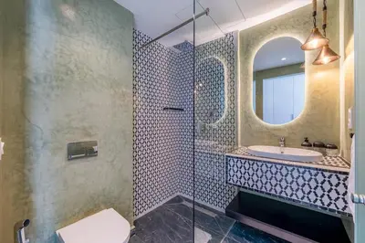 a bathroom with a sink and a mirror at Villa Lilas-Luxe Pool, Steam Room & Gym in Segraga