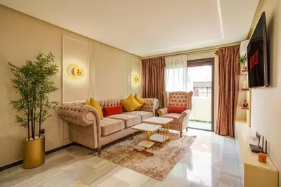 a living room with a couch and a table at Gueliz Prime 2BR Perfect Central Stay in Marrakech in Marrakech