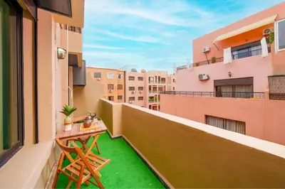 a balcony with green grass on a building at Gueliz Prime 2BR Perfect Central Stay in Marrakech in Marrakech