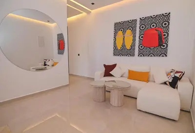a living room with a white couch and a mirror at Villa Marrakech - Argan Golf - Swimming Pool in Marrakech