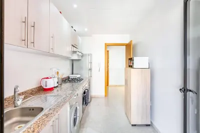 a kitchen with a sink and a refrigerator at Appartement Chic & Cosy Hivernage in Marrakech