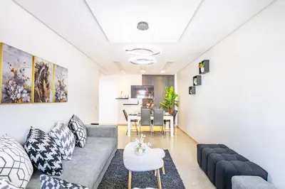 a living room with a couch and a table at Appartement Chic & Cosy Hivernage in Marrakech