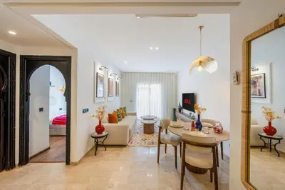 a living room with a table and a couch at Modern 1BR , Cinema & Xbox , Central Guéliz in Marrakech