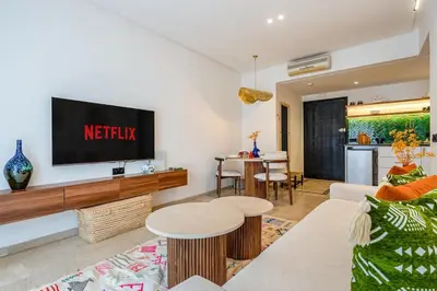 a living room with a tv on a wall at Modern 1BR , Cinema & Xbox , Central Guéliz in Marrakech