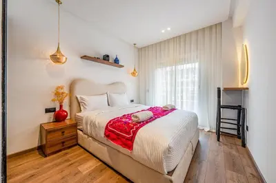 a bedroom with a large bed and a window at Modern 1BR , Cinema & Xbox , Central Guéliz in Marrakech