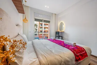 a bedroom with a large bed and a window at Modern 1BR , Cinema & Xbox , Central Guéliz in Marrakech