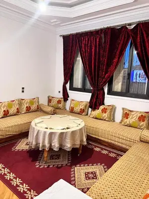 a living room with two couches and a table at Tumsilt in Marrakech
