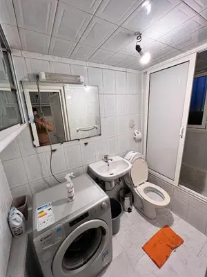 a bathroom with a washing machine and a sink at Tumsilt in Marrakech