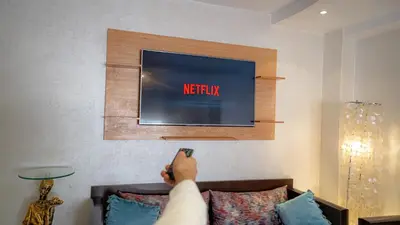 a person laying on top of a couch watching tv at Best Location in Marrakech! Modern Chic Apartment in Marrakech