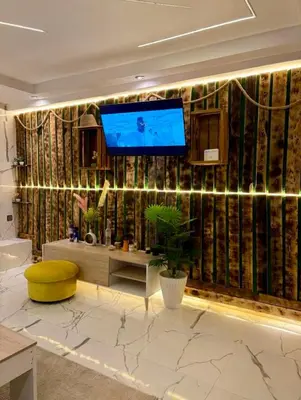 a bathroom with a large tv on a wall with aarijavascript at Madame plaza in Marrakech