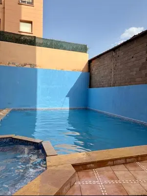 a large pool of water next to a building at Madame plaza in Marrakech
