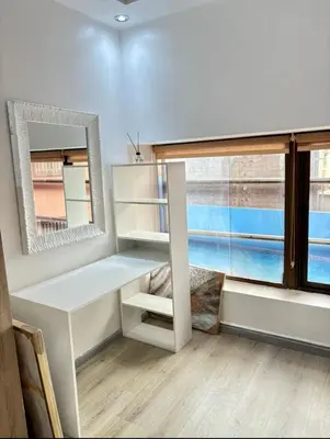 a room with a desk and a large window at Madame plaza in Marrakech