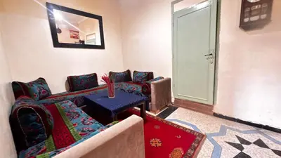 a living room with a couch and a table at Les appartements de la Koutoubia in Marrakech