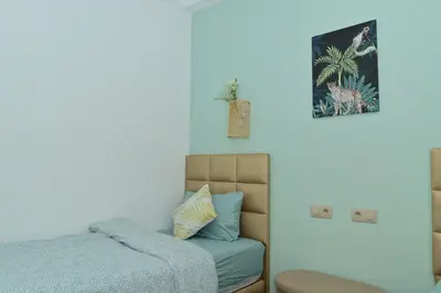 a bedroom with a bed and a picture on the wall at Stylish apartment, 5 min to airport fiber&Netflix in Marrakech