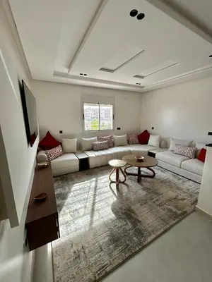 a living room with a couch and a table at Appartement 2 chambres neuf Marjane Rte de Casa in Marrakech