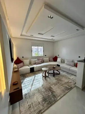 a living room with a couch and a table at Appartement 2 chambres neuf Marjane Rte de Casa in Marrakech