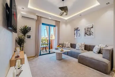 a living room with a couch and a tv at Appartement Standing Marrakech Caricia in Marrakech