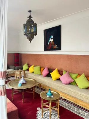 a living room with a couch with colorful pillows at RIAD Dar Aïlen Médina in Marrakech
