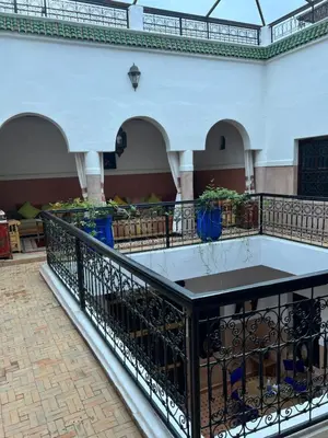 a balcony in a building with a table on it at Riad Dar Aïlen Medina in Marrakech