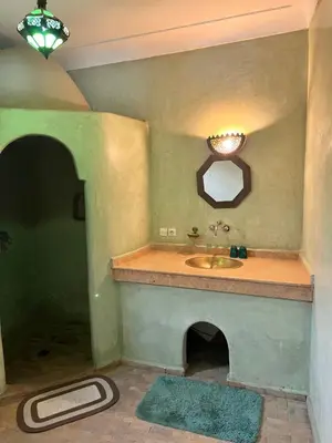 a bathroom with a sink and a mirror at Riad Dar Aïlen Medina in Marrakech