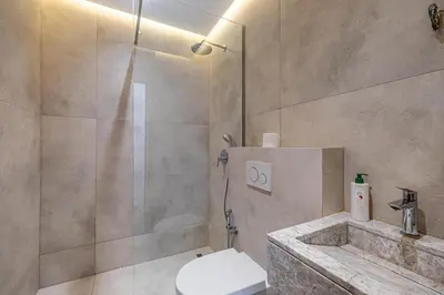 a bathroom with a shower and a toilet and a sink at Villa Alfa Élégance, Calme & Confort Premium in Marrakech