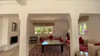 a living room with a couch and a table at Grand duplex Palmeraie in Marrakech