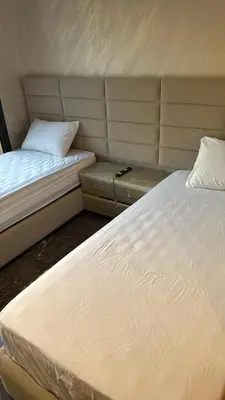 two beds sitting next to each other in a room at Elite garden Stylish Unique Appartement in Marrakech