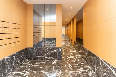 a lobby with a marble floor and wooden walls at Elite garden Stylish Unique Appartement in Marrakech