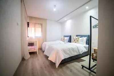 a bedroom with two beds and a window at La citrine A in Marrakech
