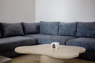 a living room with a blue couch and a coffee table at Villa de prestige avec piscine privée in Marrakech