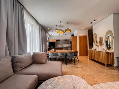 a living room with a couch and a table at Villa de prestige avec piscine privée in Marrakech
