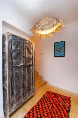 a room with a large wooden door and a rug at Riad Prive in Marrakech