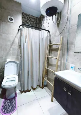 a bathroom with a shower curtain and a toilet at Hypercenter Comfy apartment Marrakech pool in Marrakech