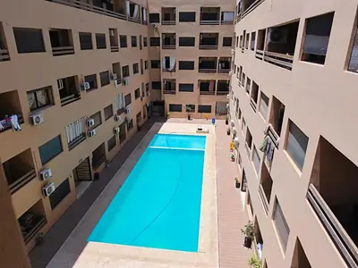 an overhead view of a swimming pool in an apartment building at Hypercenter Comfy apartment Marrakech pool in Marrakech