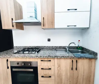 a kitchen with a sink and a stove at Hypercenter Comfy apartment Marrakech pool in Marrakech