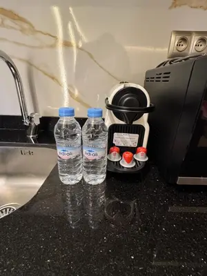two bottles of water sitting on a counter next to a sink at City Luxe Studio in Marrakech