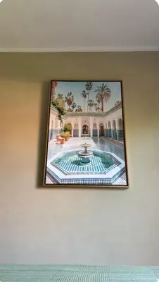 a picture of a building with a fountain on the wall at Welcome to your Stylish Atlas View Apartment in Marrakech