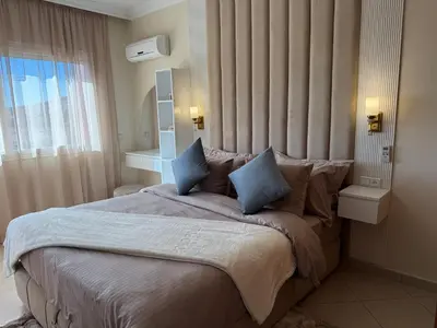 a bedroom with a large bed with blue pillows at Appartement de luxe dans le centre de Marrakech in Marrakech