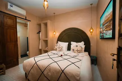 a bedroom with a large bed in a room at Riad EL Mouloudi in Marrakech